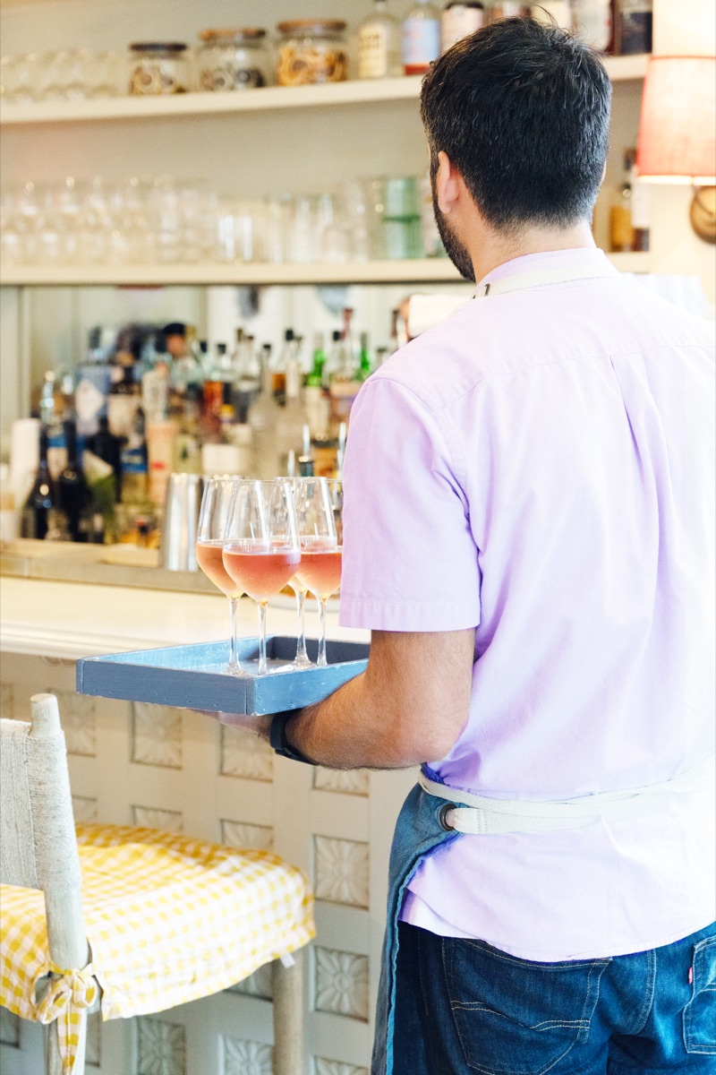 Server carrying rose at The Wayback farm-to-table cafe and bar